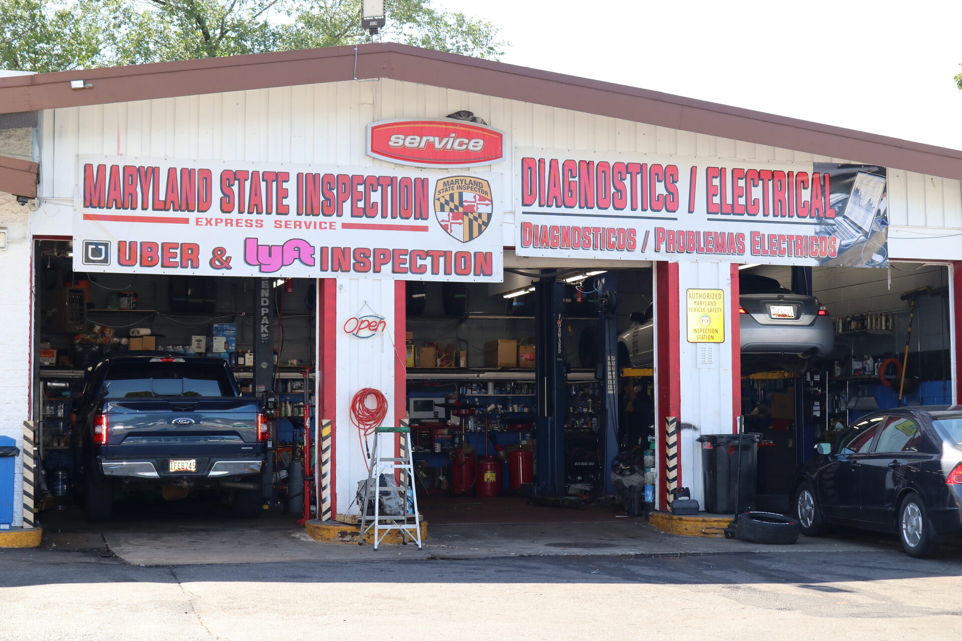 AMOCO Auto Repair shop exterior with Maryland State Inspection and Diagnostics / Electrical signage above open service bays